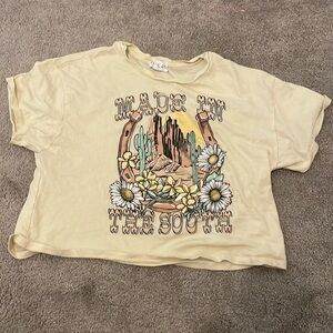This shirt is a yellow crop top made by outlaw